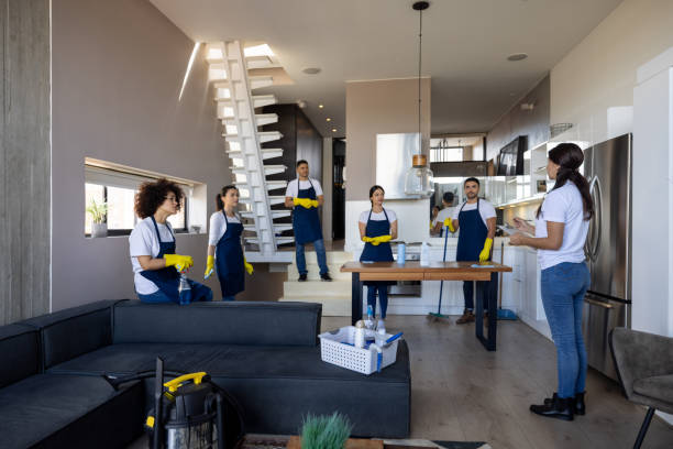 A group of women from Janitorial Services cleaning and organizing a living room together.