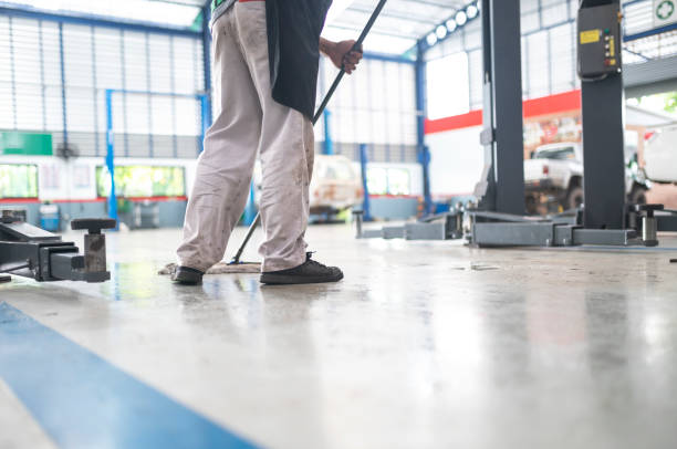 Close-up Of Cleaning Cart With Detergents, Cleaning Mop And Bucket In Shopping Mall With Blurred Background