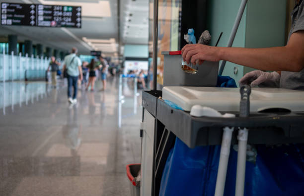 A yellow and black cleaning cart positioned in a hallway, indicating a commercial cleaning service in progress.