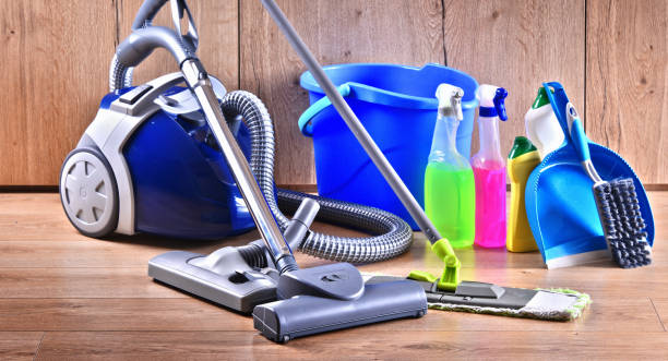 A cleaning cart featuring a broom and mop, branded with the logo of Corporate Cleaning Solutions.
